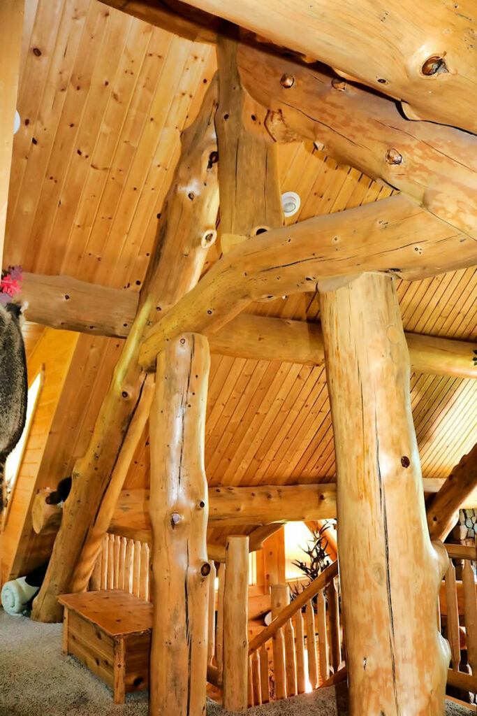 Yellowstone Log Homes loft with beams at Mcgregor Log Home 4452